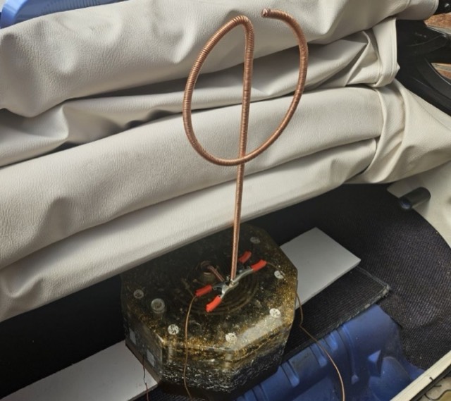 L'antenne de cuivre en forme de phi, posée sur le drap